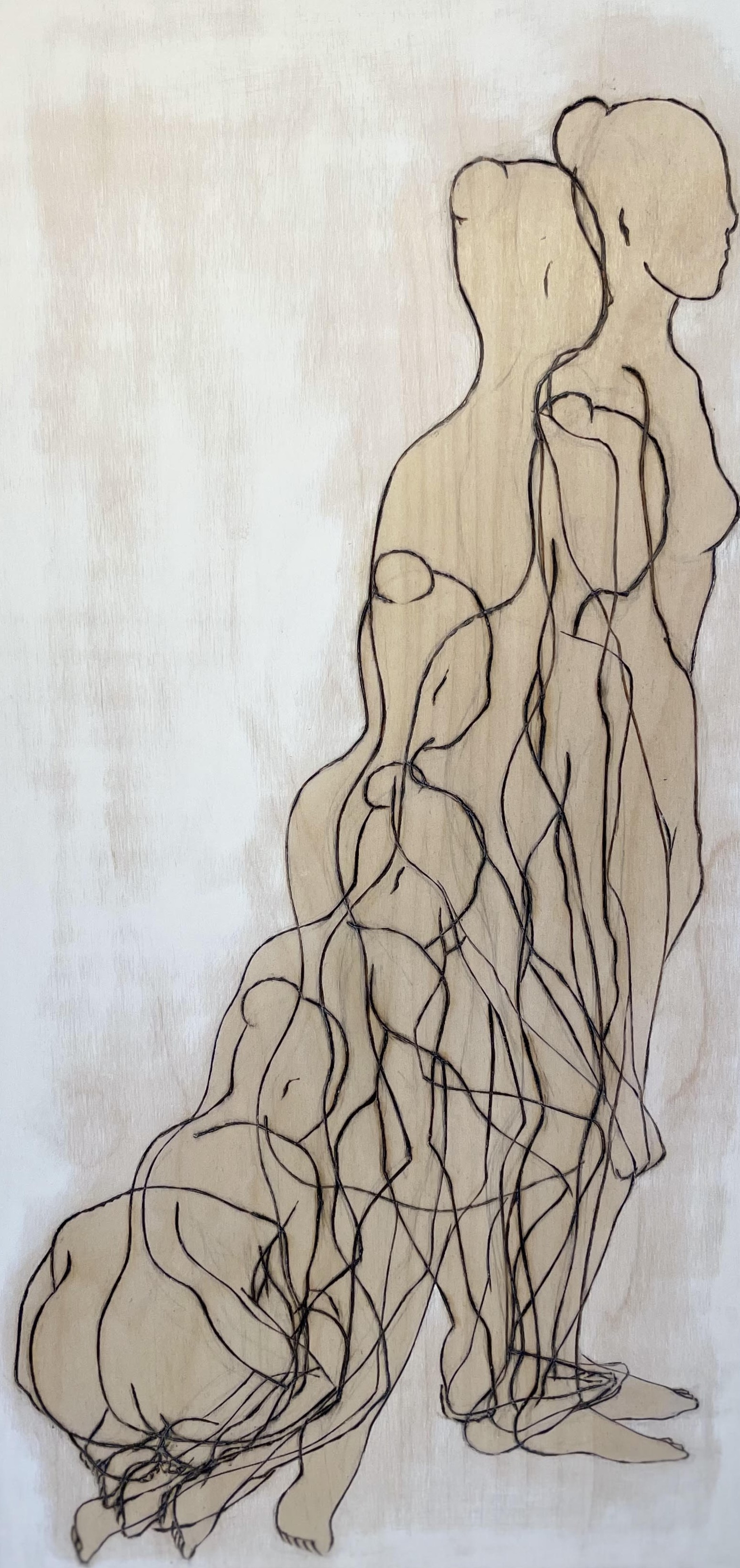 Line drawing on wood of overlapping female figures